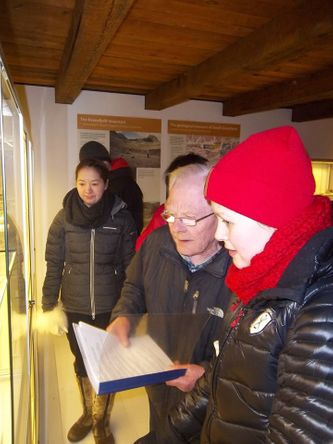 Børge is showing some students the mineral exihibition.  

Copyright: Narsaq Museum.